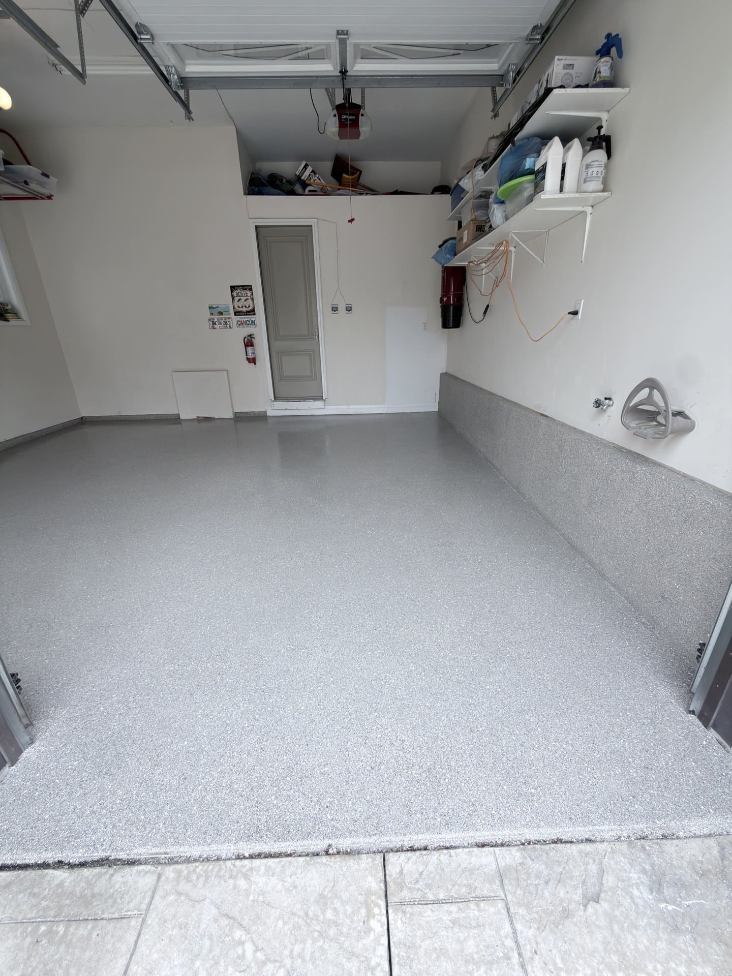 Finished grey flake garage floor with coated wall edges