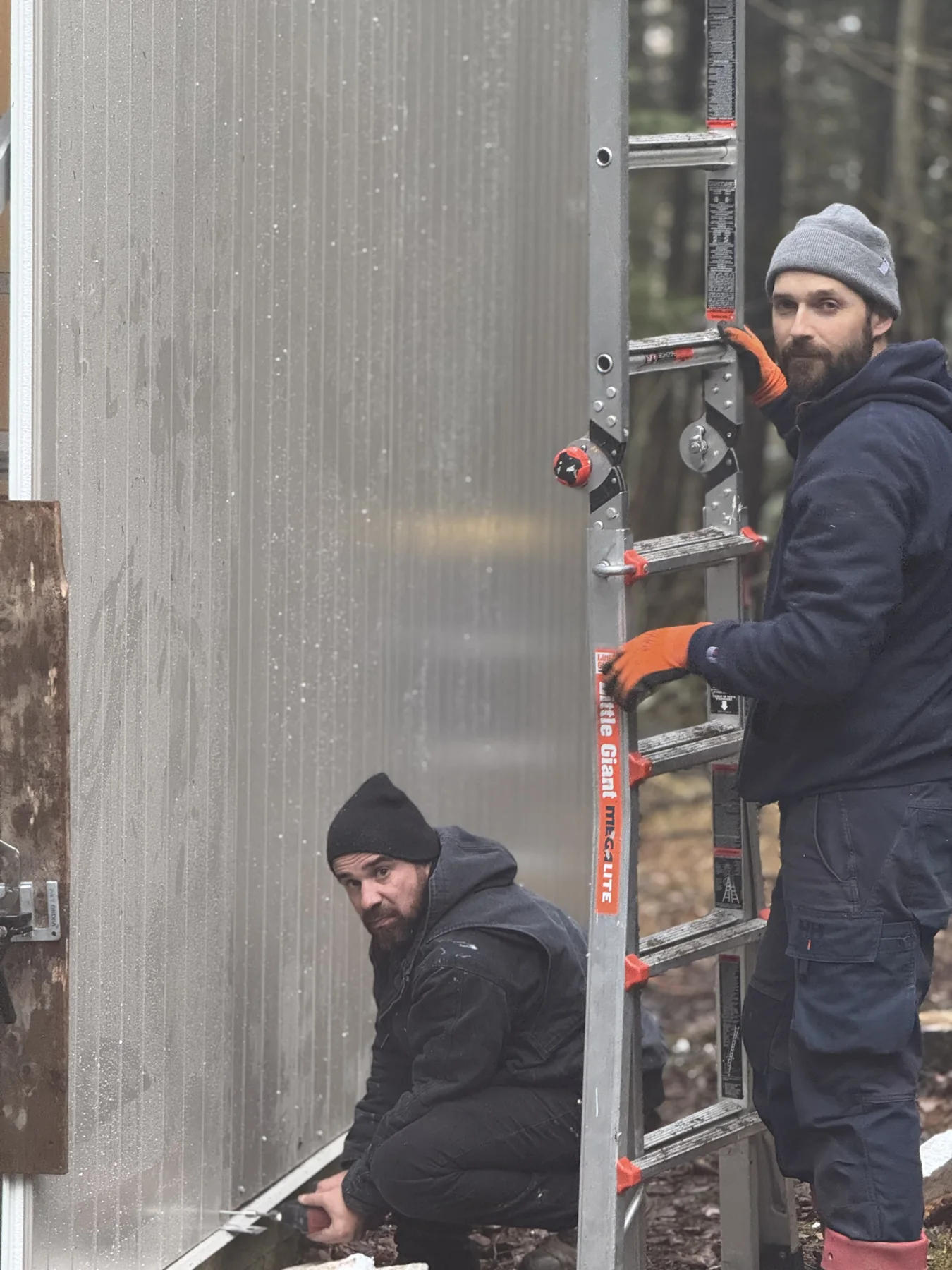 TaskMaster team members working on a building exterior
